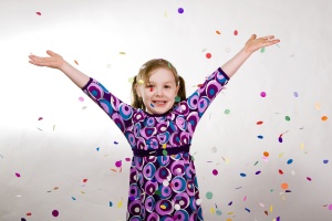 Young girl celebrating with confetti